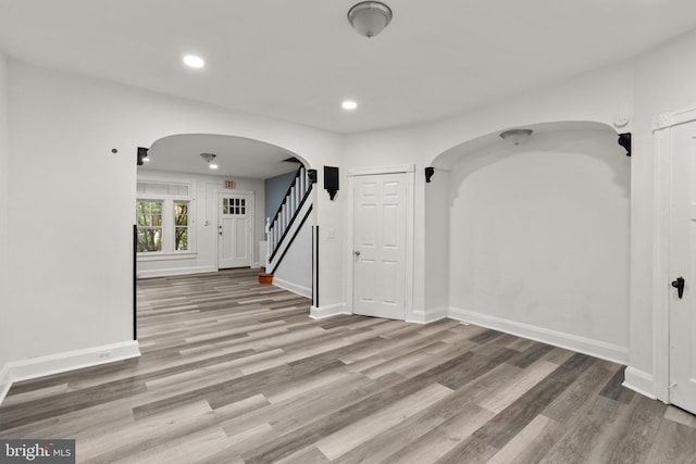 4208 Sheldon Ave, Baltimore, MD 21206 - unfurnished room featuring arched walkways, wood finished floors, baseboards, recessed lighting, and stairway