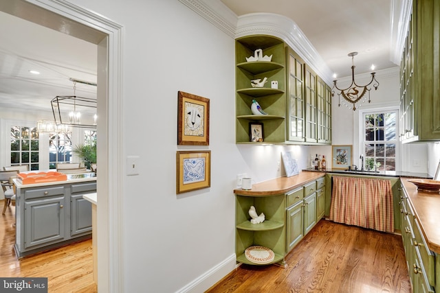 kitchen with open shelves, a chandelier, gray cabinets, ornamental molding, and green cabinets