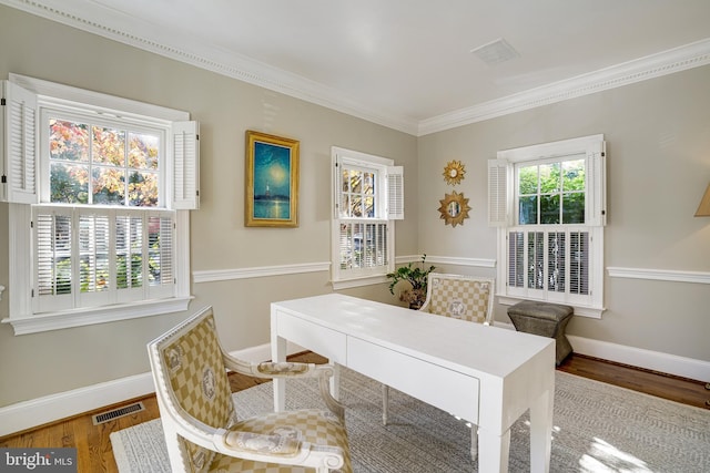 office featuring baseboards, visible vents, ornamental molding, and wood finished floors