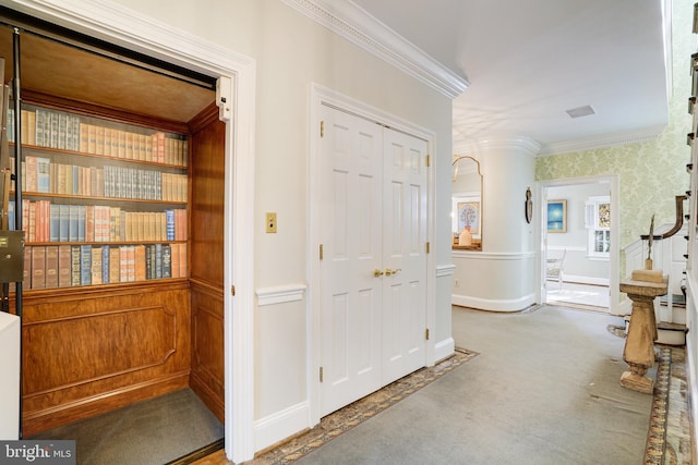 corridor with crown molding, carpet, and baseboards