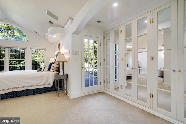 carpeted bedroom with access to outside, visible vents, french doors, and lofted ceiling