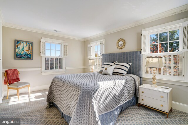 bedroom featuring visible vents, carpet flooring, multiple windows, and ornamental molding