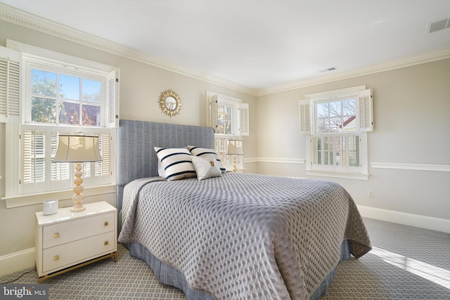 carpeted bedroom featuring visible vents, multiple windows, and ornamental molding