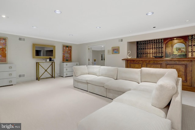 carpeted living room featuring crown molding, recessed lighting, and visible vents