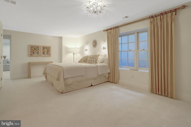 carpeted bedroom featuring visible vents, baseboards, and a chandelier