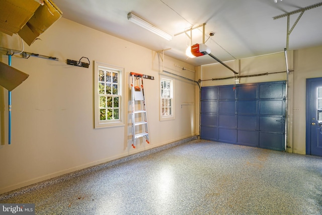 garage with baseboards and a garage door opener