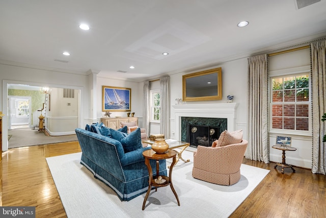 living room with a premium fireplace, recessed lighting, a wealth of natural light, and wood finished floors
