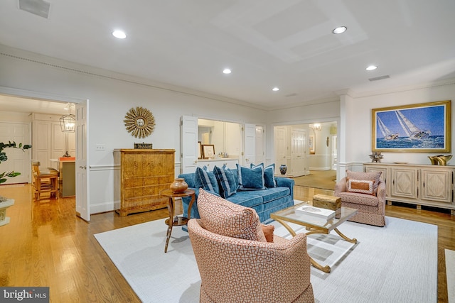 living area featuring crown molding, recessed lighting, light wood-type flooring, and visible vents
