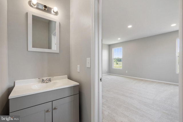 bathroom featuring recessed lighting, baseboards, and vanity