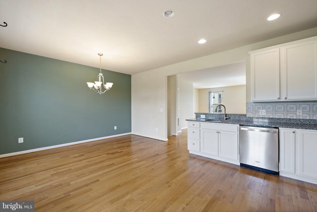 kitchen with white cabinets, a sink, a chandelier, light wood-style flooring, and stainless steel dishwasher