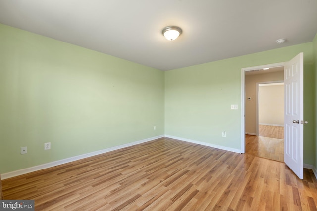unfurnished room featuring light wood-style floors and baseboards