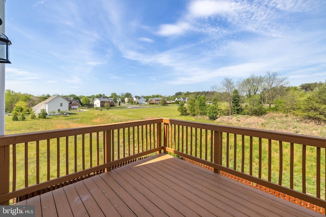 deck featuring a residential view and a yard