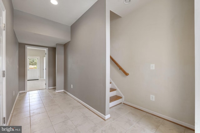 entrance foyer featuring baseboards, recessed lighting, and stairway