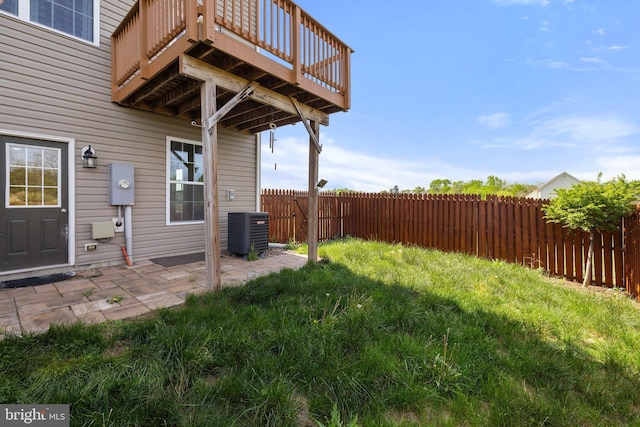 view of yard featuring a patio, cooling unit, a wooden deck, and a fenced backyard