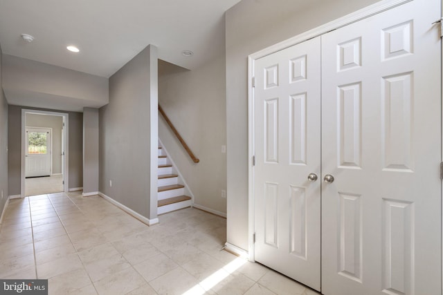 stairs with recessed lighting, baseboards, and tile patterned floors
