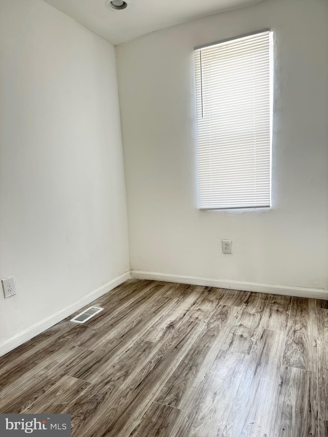 2526 W Franklin St, Baltimore, MD 21223 - spare room featuring baseboards, visible vents, and wood finished floors