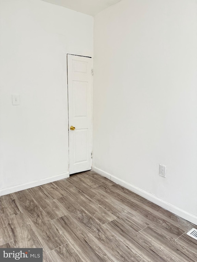 2526 W Franklin St, Baltimore, MD 21223 - spare room featuring baseboards and wood finished floors