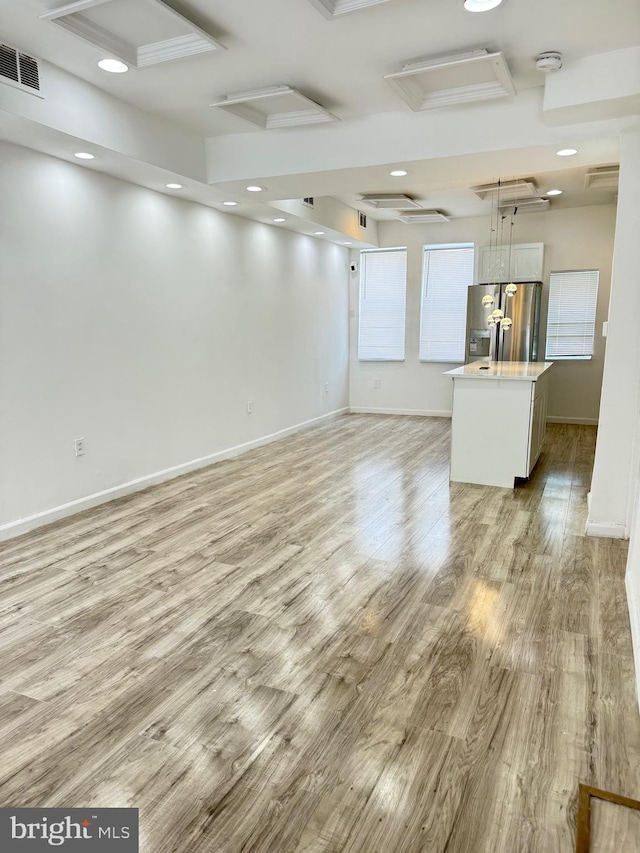 2526 W Franklin St, Baltimore, MD 21223 - unfurnished living room featuring visible vents, baseboards, attic access, recessed lighting, and light wood finished floors