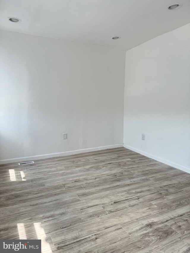 2526 W Franklin St, Baltimore, MD 21223 - empty room featuring visible vents, baseboards, and wood finished floors