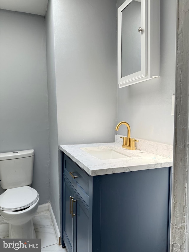 2526 W Franklin St, Baltimore, MD 21223 - bathroom featuring vanity, baseboards, toilet, and marble finish floor