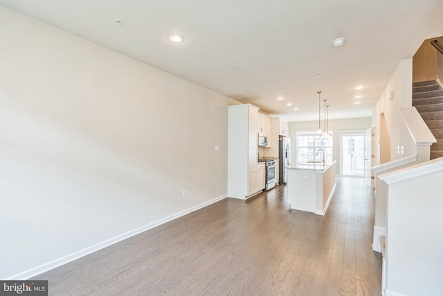 12526 Adobe Aly, Beltsville, MD 20705 - unfurnished living room featuring baseboards, recessed lighting, dark wood finished floors, and stairway
