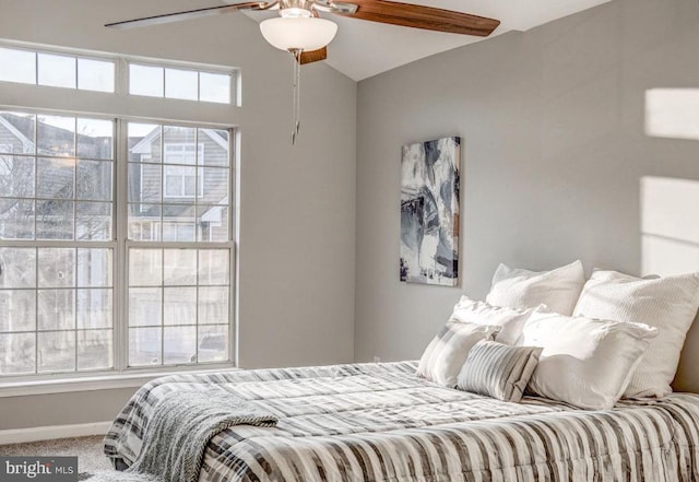 bedroom with baseboards, a ceiling fan, carpet, and lofted ceiling