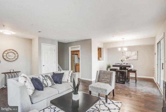 living room with baseboards and dark wood finished floors