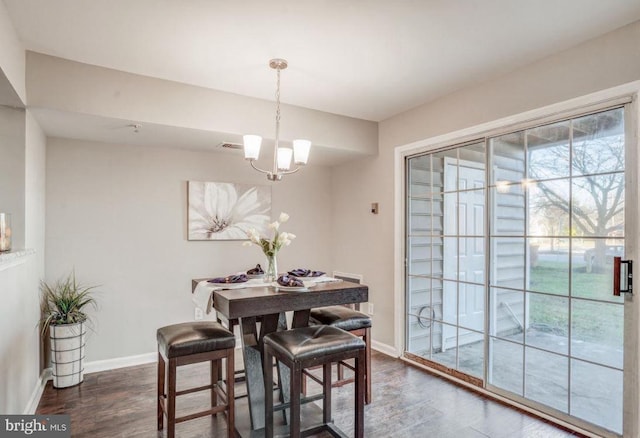 dining space with an inviting chandelier, baseboards, dark wood-style floors, and visible vents
