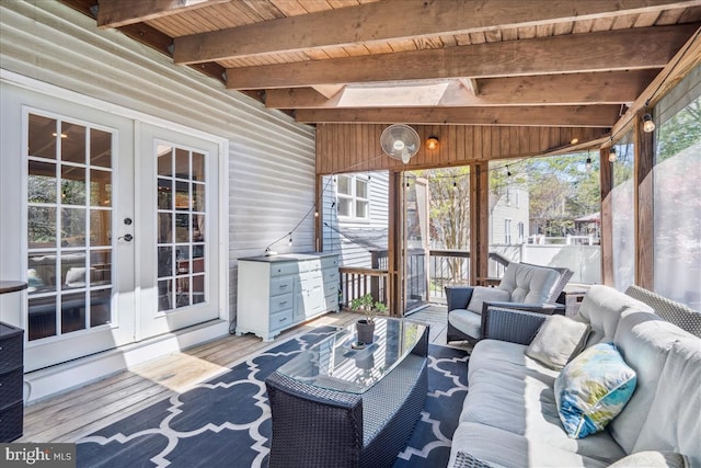 sunroom / solarium featuring french doors, an outdoor hangout area, and beam ceiling
