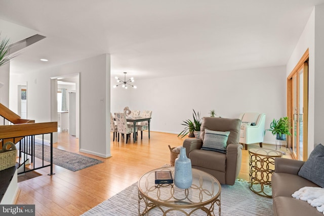 11645 Newbridge Ct, Reston, VA 20191 - living room featuring light wood-type flooring, a chandelier, baseboards, and stairway