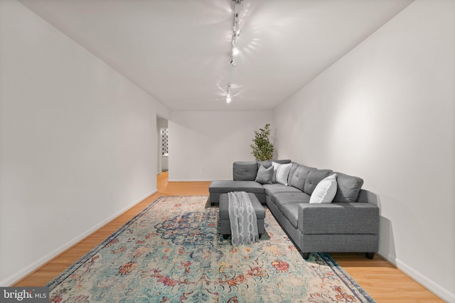 11645 Newbridge Ct, Reston, VA 20191 - living room with track lighting, light wood finished floors, and baseboards