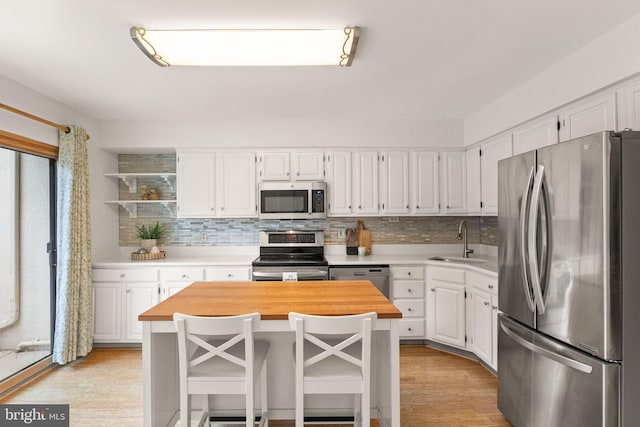 11645 Newbridge Ct, Reston, VA 20191 - kitchen featuring appliances with stainless steel finishes, a sink, open shelves, wood counters, and white cabinets