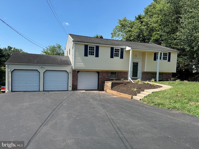 14 Featherbed Ln, Norristown, PA 19403 - bi-level home featuring brick siding, a garage, and aphalt driveway