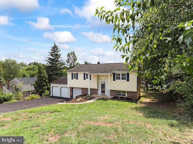 14 Featherbed Ln, Norristown, PA 19403 - raised ranch featuring a garage, brick siding, a front lawn, and aphalt driveway