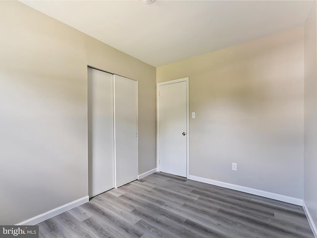 14 Featherbed Ln, Norristown, PA 19403 - unfurnished bedroom featuring baseboards, wood finished floors, and a closet