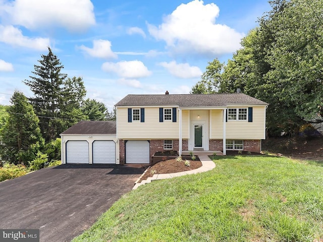 14 Featherbed Ln, Norristown, PA 19403 - split foyer home featuring a garage, brick siding, a front lawn, and aphalt driveway