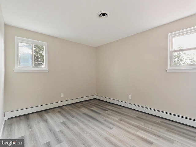 14 Featherbed Ln, Norristown, PA 19403 - spare room featuring a baseboard heating unit, visible vents, and light wood-style floors