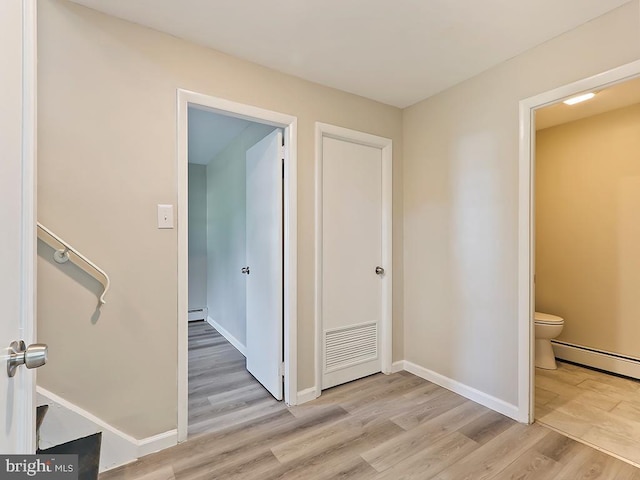 14 Featherbed Ln, Norristown, PA 19403 - hallway featuring baseboards, visible vents, light wood-style flooring, and a baseboard radiator
