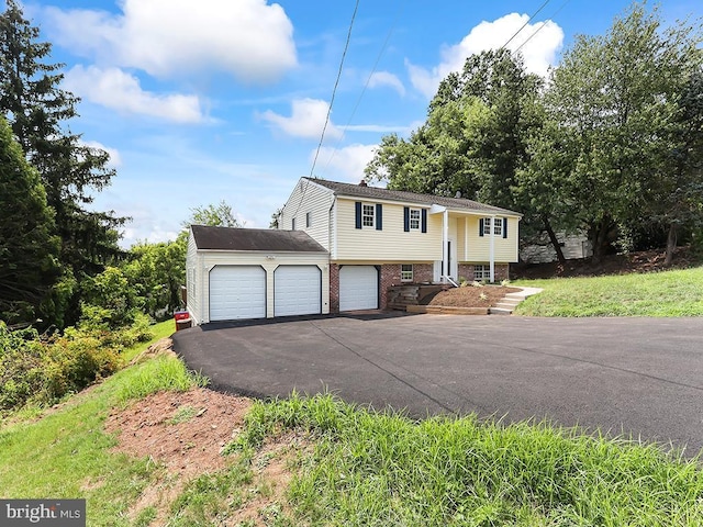 14 Featherbed Ln, Norristown, PA 19403 - split foyer home with an attached garage, aphalt driveway, and brick siding