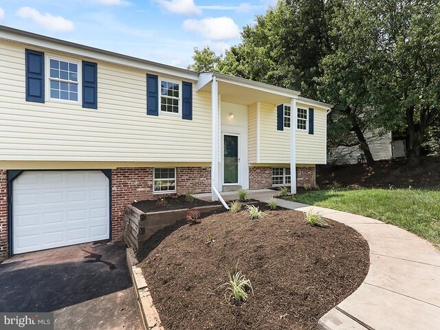 14 Featherbed Ln, Norristown, PA 19403 - split foyer home with brick siding, an attached garage, and aphalt driveway