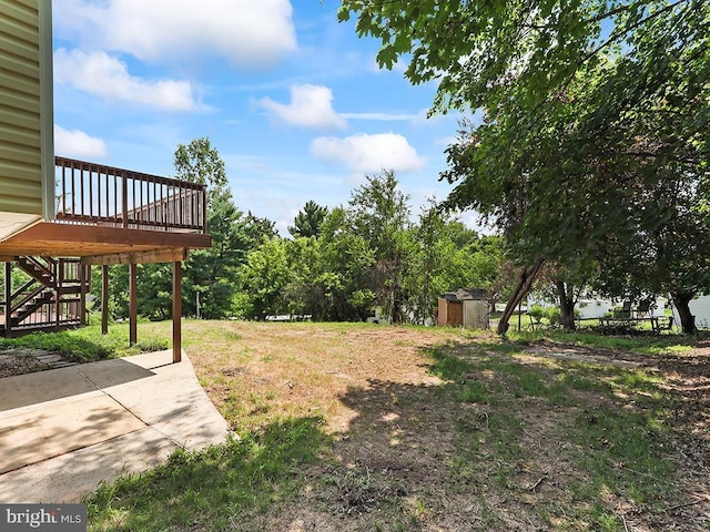 14 Featherbed Ln, Norristown, PA 19403 - view of yard featuring an outdoor structure, a wooden deck, stairs, a patio area, and a storage shed