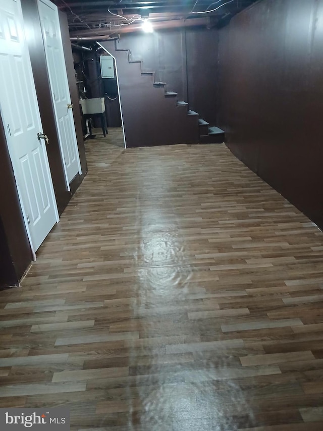 below grade area featuring stairs and wood finished floors