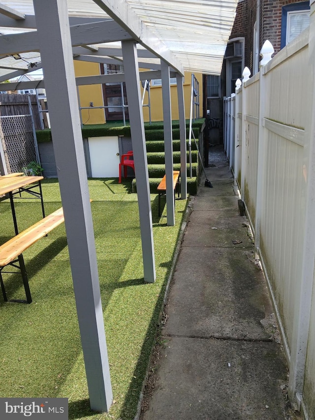 exterior space featuring a lawn and fence