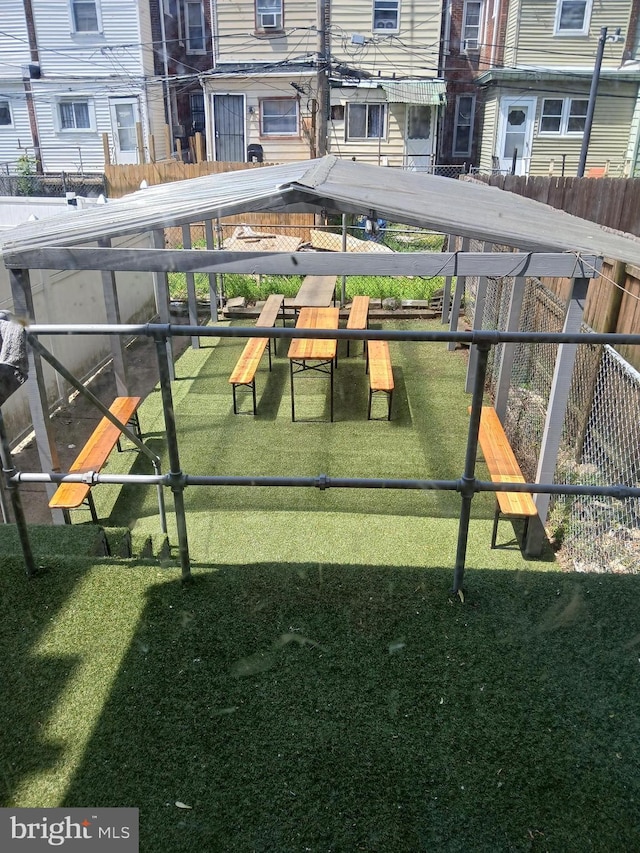 view of community with fence and a yard