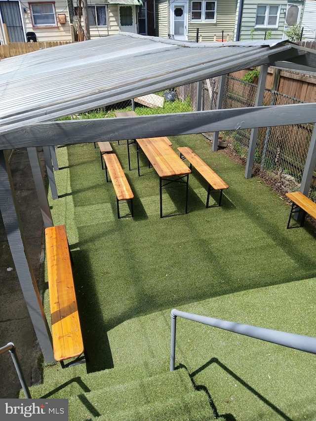 view of home's community featuring fence