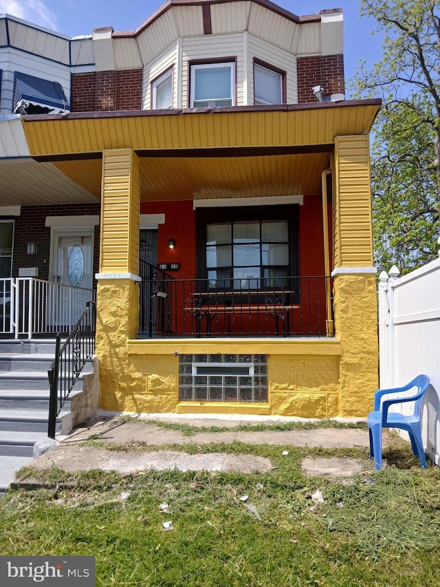 view of front of house featuring covered porch and brick siding
