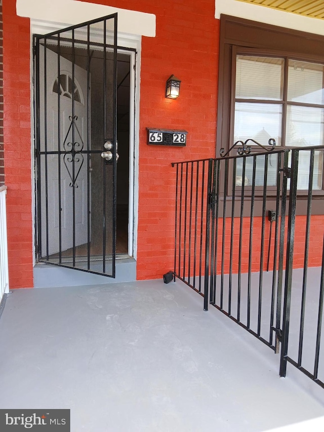 doorway to property with brick siding