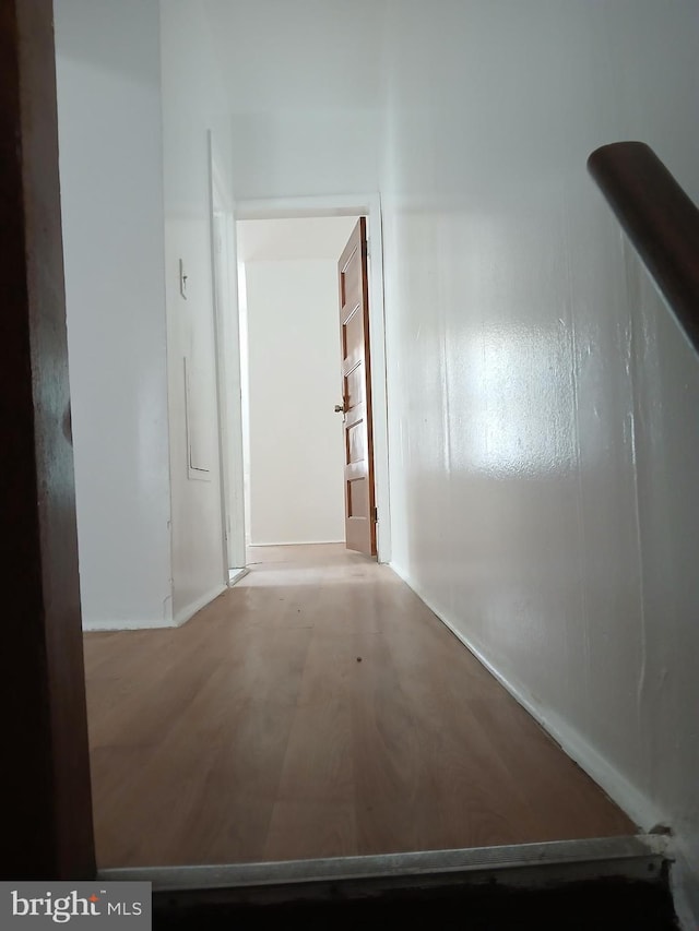 hall featuring baseboards