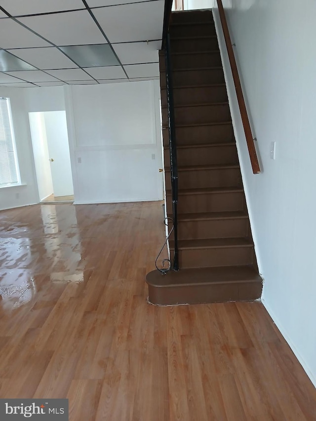 stairs featuring baseboards and wood finished floors