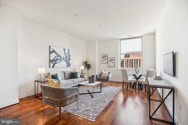 living room with baseboards and dark wood-style flooring
